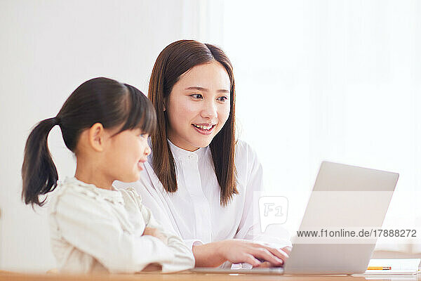 Japanese kid and mother studying at home