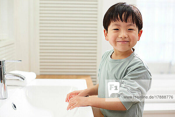 Japanese kid washing hands at home