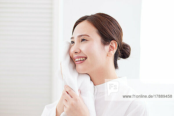 Japanese woman washing face at home