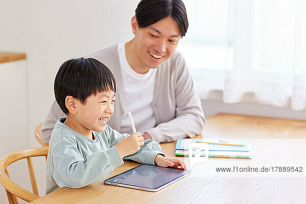 Japanese kid and father studying at home