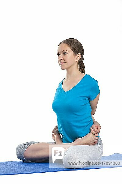 Yoga  young beautiful woman yoga instructor doing bound lotus pose (Baddha Padmasana) exercise isolated on white background