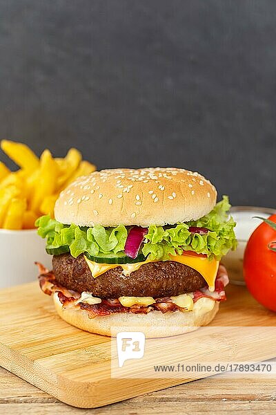 Hamburger cheeseburger fast food meal with fries on wooden board in Stuttgart  Germany  Europe