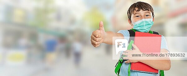 Young Pupil Child Boy With Mask Against Corona Virus Corona Virus In City Showing Thumbs Up With Text Free Space Copyspace in Stuttgart  Stuttgart  Germany  Europe