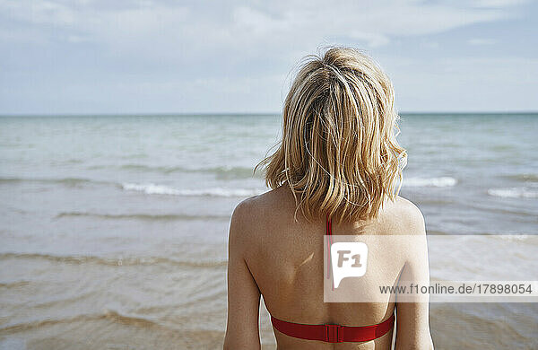 Woman in blond hair looking at sea