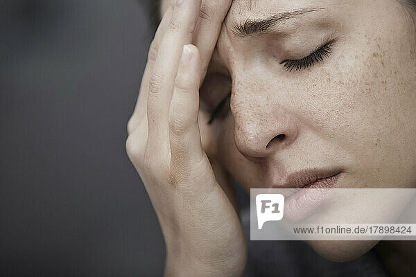 Sad woman suffering from headache