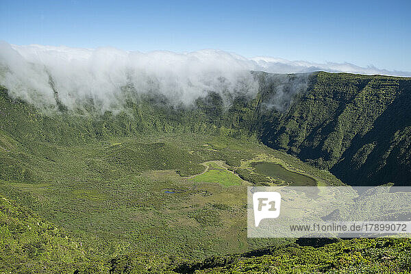 Portugal  Azores  Clouds pouring into vast green caldera