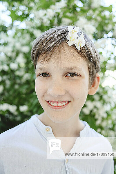 Happy boy with jasmine flower in hair