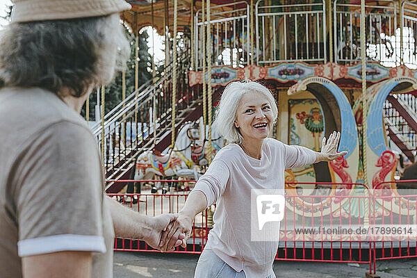 Happy couple enjoying together at amusement park