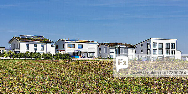 Germany  Baden-Wurttemberg  Sindelfingen  Field in front of modern suburban houses