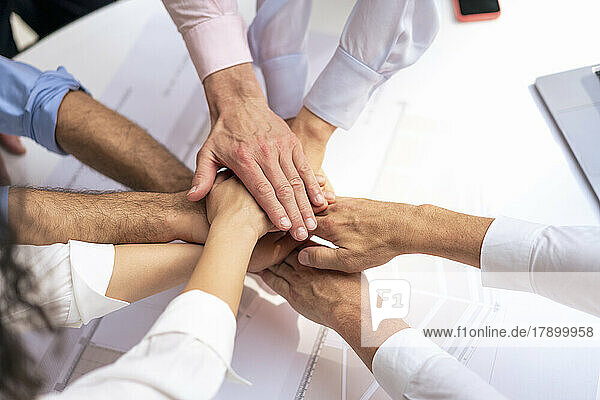 Business people stacking hands in meeting