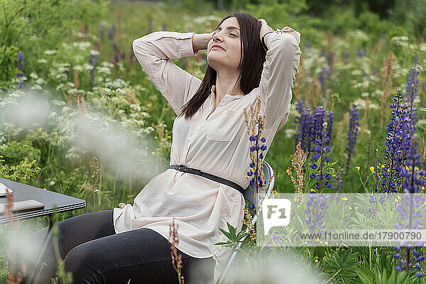 Freelancer relaxing amidst lupine flowers