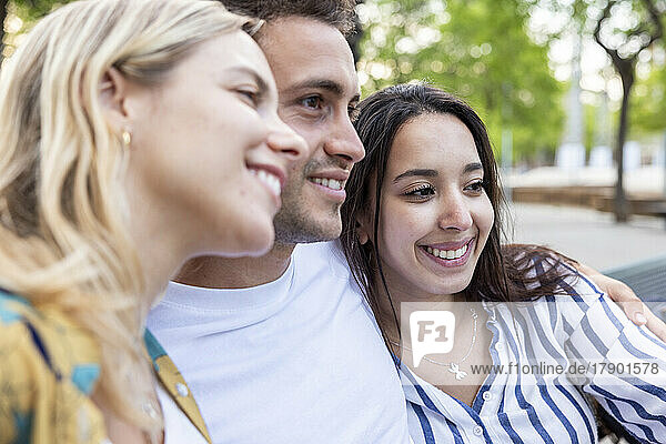 Happy young women with man at park