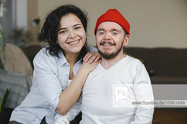Smiling couple in living room at home