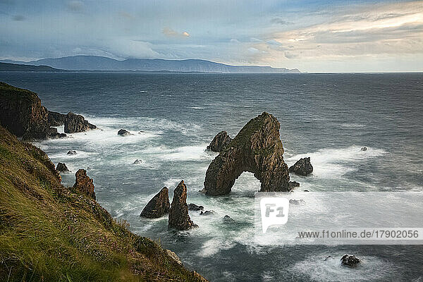 Famous Crohy Head Sea Arch in sea at sunset  County Donegal  Ireland