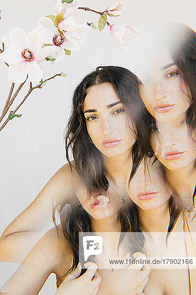 Multiple exposure of young woman with flowers