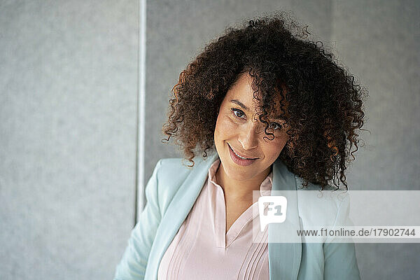 Smiling mature businesswoman with curly hair
