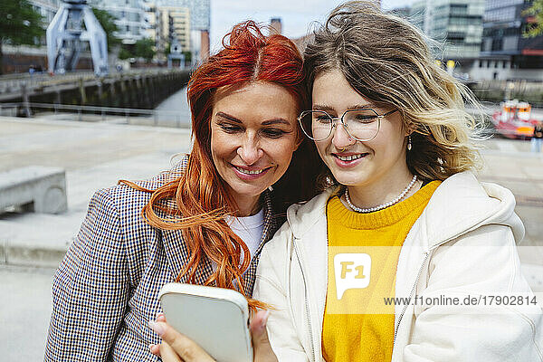 Happy mother and daughter taking selfie at Hafencity