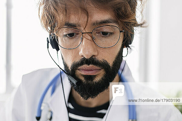 Doctor wearing headset working from home office