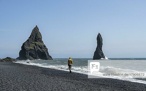 Tourist an schwarzem Strand  Felsen Reynisdrangar im Wasser  am Reynisfjara Strand  Vik  Südisland  Island  Europa