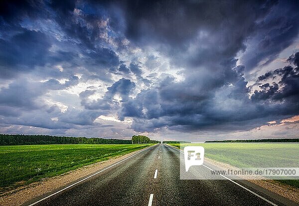 Travel concept background  road and stormy dramatic sky