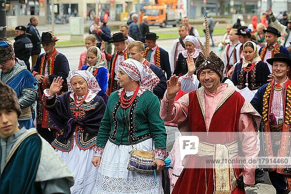 A man waves to the camera at the Oktoberfest Costume and Riflemens Parade where people wear lovely colourful traditional suits and dresses. Munich  Germany  Europe