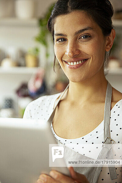 Young adult female entrepreneur smiling at the camera