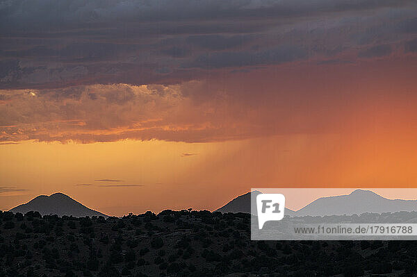 Usa  New Mexico  Lamy  Dramatic sunset sky over desert landscape