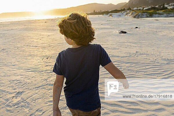 Boy (8-9) walking on Grotto Beach