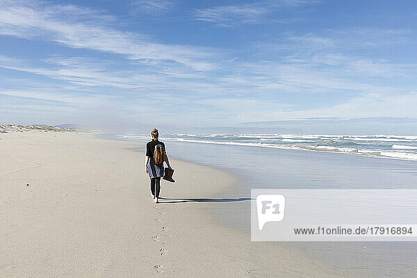 South Africa  Hermanus  Teenage girl (16-17) walking along Grotto Beach