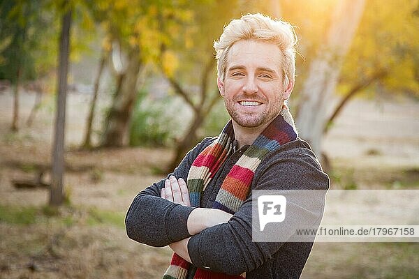 Handsome young adult male wearing scarf portrait outdoors
