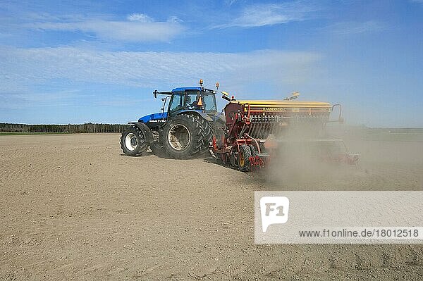 New Holland TM150 tractor with Vaderstad seed drill  with windblown dust in the field  Sweden  Europe