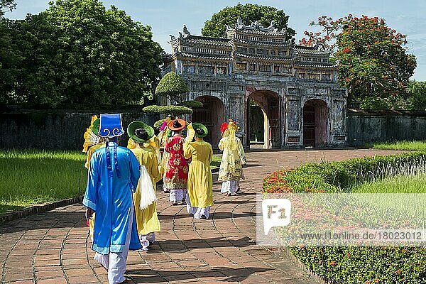Vietnamese extras in traditional costumes going through West Gate  Chuong Duc  Imperial Palace Hoang Thanh  Forbidden City  Hue  Vietnam  Asia