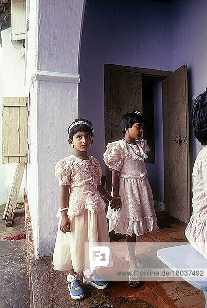 Girls Standing in Holy Virgin Mary Church  Valiyapally Kottayam  Kerala  India  Asia