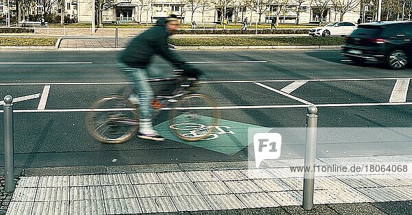 Radfahrer auf dem breiten Fahrradweg in der Karl-Marx-Allee  Berlin  Deutschland  Europa