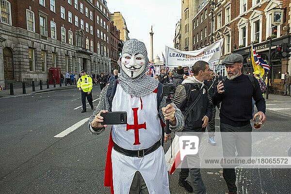 Man in St George uniform with mobile phone at a Leave means Leave march  Westminster  London  England  United Kingdom  Europe