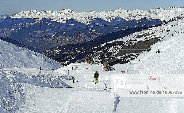 Skier jumps over ski jump in fun park  Trois 3 Vallees ski resort  Meribel-Mottaret  Haute Savoie  High Savoie  France  Europe