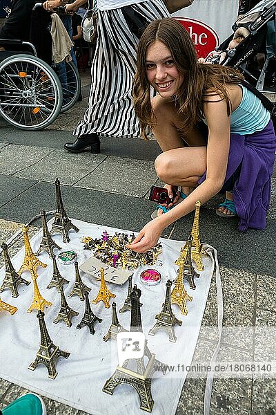 Girl buys Eiffel Tower model as souvenir  Paris  France  Europe