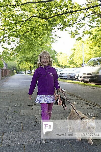 Girl (5) with dog  walking dog  Kiel  Germany  Europe