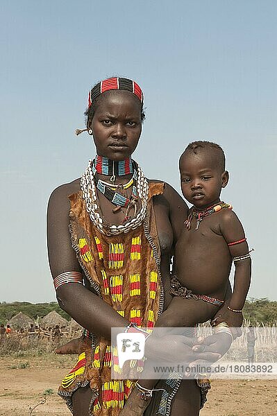 Hamar woman with baby  necklace of cowrie shells and coloured beads  Omo Valley  Southern Ethiopia  Hamar
