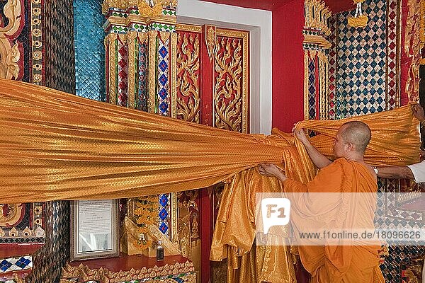 Monk attaches Songkran temple decoration  Wat Bang Riang  Buddhist temple  Thap Put  Amphoe hap Put  Phang Nga province  Thailand  Southeast Asia  Asia