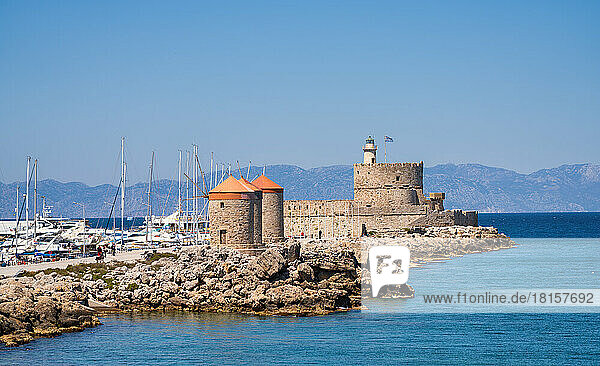 The Saint Nicholas Fortress and windmills at Mandraki Harbor  Rhodes  Dodecanese  Greek Islands  Greece  Europe