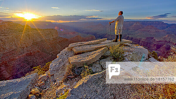 A hiker watching the sun go down west of Moran Point at Grand Canyon  Grand Canyon National Park  UNESCO World Heritage Site  Arizona  United States of America  North America
