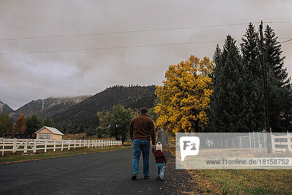dad and daughter taking a walk outdoors in the autumn with mount
