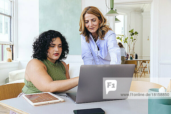 Multiracial businesswomen discussing business strategy over laptop