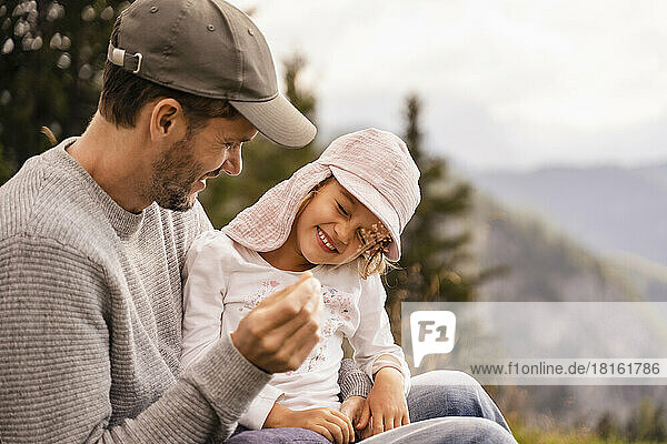 Happy girl with father enjoying outdoors