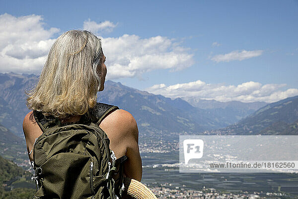 Senior woman with gray hair looking at landscape on sunny day