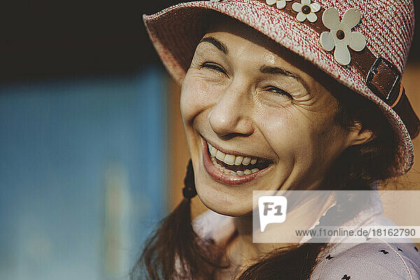 Smiling mature woman wearing bucket hat