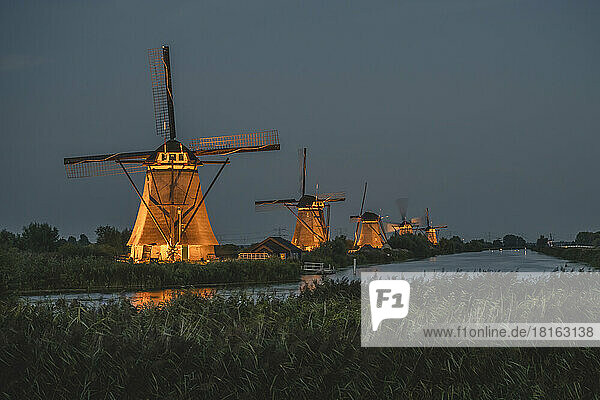 Netherlands  South Holland  Kinderdijk  Countryside river and historic windmills at night