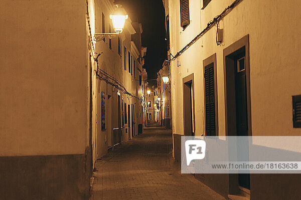 Spain  Balearic Islands  Ciutadella de Menorca  Empty illuminated alley at night