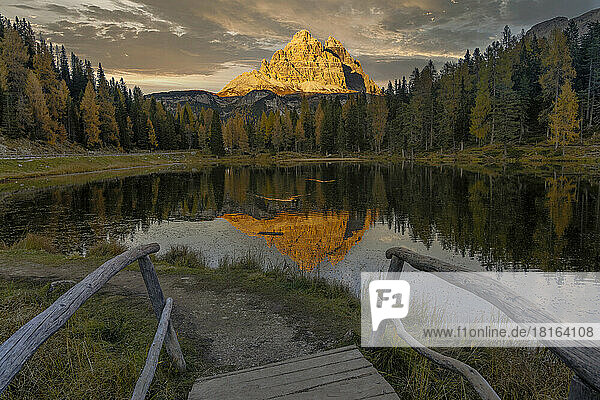 Italy  Veneto  Wooden steps in front of Lake Antorno at dusk with Tre Cime di Lavaredo peaks in background